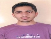 Portrait of Dr. Kapoor wearing traditional attire with academic books in background